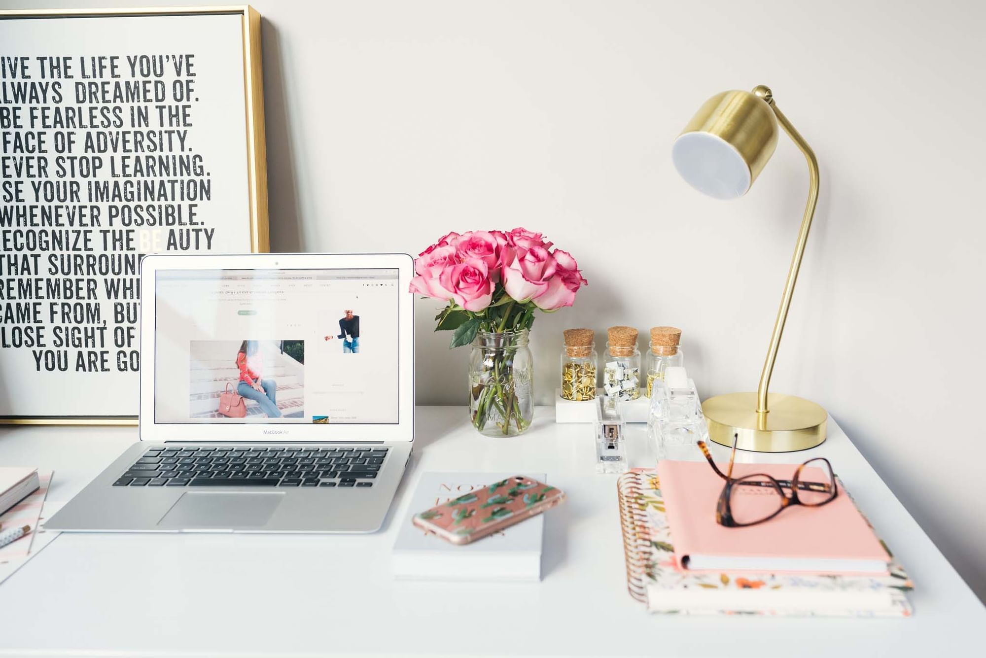 Modern desk with laptop, roses in a jar, and stationery at Sunway Velocity Hotel